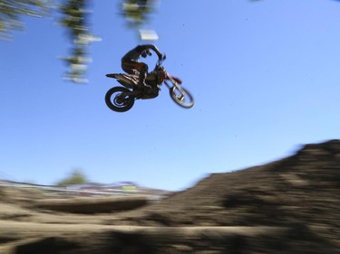 A rider flies between to jumps as he competes in Canada's only Urban Endurocross Challenge, the Red Bull Rocks & Logs at Wild Rose MX park in Calgary, on September 12, 2015.
