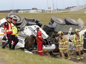 Investigators at the scene of a single vehicle concrete mixer truck rollover at Crowchild Trail and Stoney Trail early Tuesday morning, September 8, 2015, in Calgary.