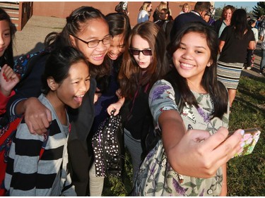 Students take a photo after reuniting following the summer on the first day of school at St. Stephen School (K-9) on Tuesday September 1, 2015.