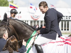 McLain Ward, seen celebrating a win during the Continental Cup at Spruce Meadows earlier this year, won the opening event of the Masters tournament on Wednesday, the Telus Cup, despite suffering through lost luggage on the flight in.