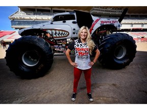 Monster truck driver Cynthia Gauthier, 27, poses with her truck Monster Mutt  at the Stampede Grounds in Calgary on Sept. 11, 2015.