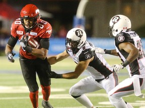 Calgary Stampeders slotback Eric Rogers leaps to avoid Ottawa Redblacks defensive back Antoine Pruneau during an August meeting between the CFL teams. Rogers leads the league in receiving yards with teammate Marquay McDaniel sitting third.