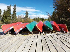 Canoes waiting to be paddled by happy campers.