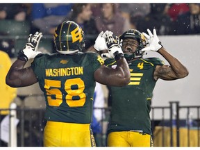 Edmonton Eskimos Tony Washington (58) and Adarius Bowman (4) celebrate a touchdown against the Calgary Stampeders during first half action in Edmonton, Alta., on Saturday September 12, 2015.