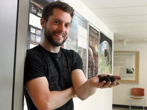 University of Calgary research assistant Lincoln Hanton holds a simulated meteorite sample that resembles a space rock that fell near Banff last December. Hanton and his team are hoping to recover fragments of that meteorite for study into the origin of the solar system.