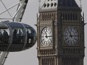 Visitors of the London Eye look at Big Ben during a September morning in London, (AP Photo/Frank Augstein)