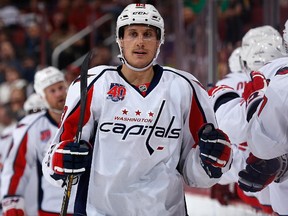 Jay Beagle #83 of the Washington Capitals celebrates with teammates on the bench after scoring a first period goal against the Arizona Coyotes during the NHL game at Gila River Arena on November 18, 2014 in Glendale, Arizona.