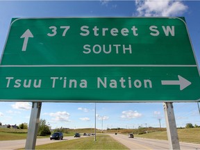 Traffic drives past a direction sign on Anderson Road S.W., which sits just outside the entrance to the Tsuut'ina Nation.
