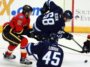 Winnipeg Jets' Ryan Olsen (68) skates by Calgary Flames' Kenny Agostino (51) during first period NHL rookie action as Jets' Jimmy Lodge (45) looks on in Penticton, B.C. on Friday September 11, 2015.
