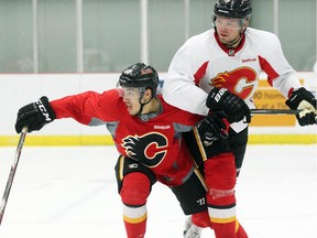 Calgary Flames left winger Ryan Lomberg, left, and defenceman Douglas Murray came together as they skated during a scrimmage during the teams training camp at Winsport on September 18, 2015.