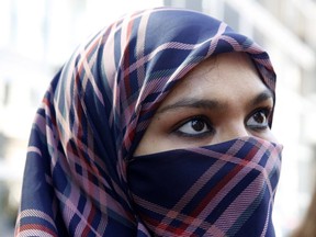 Zunera Ishaq talks to reporters outside the Federal Court of Appeal in Ottawa after her case was heard on whether she can wear a niqab while taking her citizenship oath.