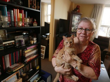 Louise Slade holds her kitten Samantha in her new apartment on Thursday October 8, 2015. Slade found a pet friendly apartment with Trinity Place Foundation after being evicted from her old home.