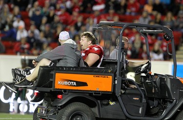 Calgary Stampeders Dan Federkeil is carted off the field after he was injured during their game against the Edmonton Eskimos at McMahon Stadium in Calgary on October 10, 2015 .