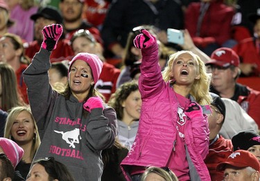 Fans sing during the Calgary Stampeders and Edmonton Eskimos Pink Power game at McMahon Stadium in Calgary on October 10, 2015 .