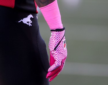 Calgary Stampeders player wears pink in support of cancer during their game against the Edmonton Eskimos at McMahon Stadium in Calgary on October 10, 2015 .