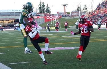 Calgary stampeders Brandon McDonald, right, intercepts the ball intended for Edmonton Eskimos Derel Walker during their game at McMahon Stadium in Calgary on October 10, 2015 .