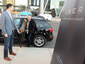 Uber driver Paul Lee held the door as Calgary businessman and philanthropist Brett Wilson climbed out of the back of Lee's Uber vehicle after catching a ride downtown as rider zero during the morning rush hour on Oct. 15, 2015.