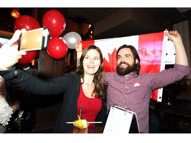 Liberal supporters Jessica Lindal and her boyfriend Stephen Peasley celebrated in the Calgary Centre headquarters of Liberal candidate Kent Hehr on Oct. 19, 2015.