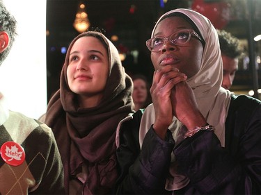 Liberal supporters Ala Buzreba, left, and Aishat Gbadamosi waited and watched as the results rolled in at the Calgary Centre headquarters of Liberal candidate Kent Hehr as a media outlet declared a Liberal majority government on Oct. 19, 2015.