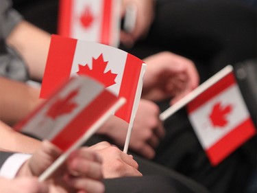 Conservative supporters hold Canadian flags as early results indicate a Liberal majority at Stephen Harper's campaign party on Monday night, Oct. 19, 2015.