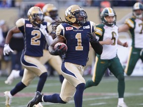 Winnipeg Blue Bombers' Troy Stoudermire (1) runs in the punt return for the touchdown against the Edmonton Eskimos during the first half of CFL action in Winnipeg Saturday, October 3, 2015. THE CANADIAN PRESS/John Woods