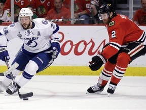 Tampa Bay Lightning&#039;s Ryan Callahan, left, handles the puck as Chicago Blackhawks&#039; Duncan Keith watches during the first period in Game 6 of the NHL hockey Stanley Cup Final series on Monday, June 15, 2015, in Chicago.Keith will be sidelined for four to six weeks after he had right knee surgery on Tuesday. THE CANADIAN PRESS/ AP/Nam Y. Huh