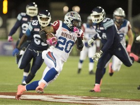 Montreal Alouettes running back Tyrell Sutton (20) runs the ball against the Toronto Argonauts during first half of CFL football action in Hamilton, Ontario on Friday, October 23, 2015. THE CANADIAN PRESS/Peter Power