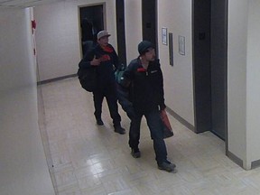 Calgary police released this surveillance image of two men believed responsible for a series of car prowlings in the city.