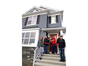 Jack James High School students joined Homes by Avi chairman Avi Amir to officially launch the new home in Nolan Hill that the students helped build. From left, Kayla Dorey, Avi Amir, Chase Imeson, Connor Bradley, Trueman Hughes, Tyler Johnston and Trysten Herman.