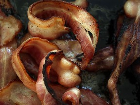 In this photo illustration, bacon cooks in a frying pan on Oct. 26, 2015 in Miami, Florida. A report released today by the World Health Organization's  International Agency for Research on Cancer announced that eating processed meat can lead to colorectal cancer in humans even as it remains a small chance but rises with the amount consumed.