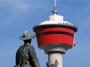 A statue of a soldier on horseback honouring Canadians who died in the Boer War looks out towards the Calgary Tower from Central Memorial Park.