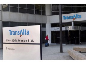A woman walks towards the entrance of the TransAlta headquarters building in Calgary, on Tuesday, April 29, 2014. The Alberta Utilities Commission concluded in July that TransAlta Corp. timed power outages at power plants at peak times to drive up electricity prices.