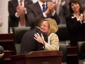 Finance Minister Joe Ceci is embraced by Premier Rachel Notley after delivering the 2015 provincial budget. Reader says the budget will set Alberta on a course to ending up like Greece.