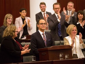 Alberta Finance Minister Joe Ceci, centre, receives a round of appause after delivering the 2015 provincial budget at the Legislative Assembly in Edmonton on Tuesday, Oct. 27, 2015.