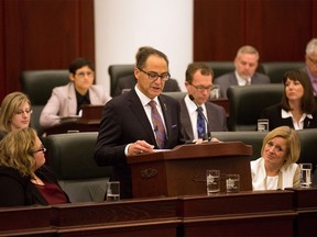 Alberta Finance Minister Joe Ceci, centre, delivers the 2015 provincial budget in Edmonton on Tuesday, Oct. 27, 2015.