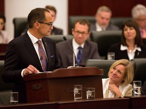 Alberta Finance Minister Joe Ceci, left, exchanges glances with Alberta Premier Rachel Notley, right, as he delivers the 2015 provincial budget in Edmonton on Tuesday, Oct. 27, 2015.