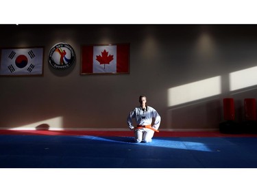 Olympic luge athlete Kim McRae meditates during a taekwondo lesson at Master Rim's Taekwondo on October 6, 2015. McRae is preparing for the 2018 Winter Olympics in Pyeongchang South Korea, by studying Korea's national sport.
