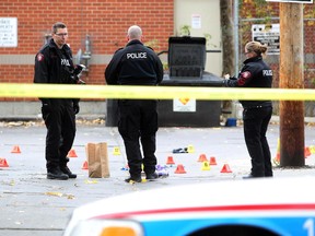 Members of the Calgary Police Service Ident Unit were busy investigating after a man was found dead in an alley in the 700 block between 11th and 12th Ave SW on Oct. 12, 2015.