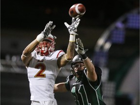 University of Calgary Dinos receiver Rashaun Simonise goes up for a catch over 
University of Saskatchewan Huskies defender Vince Greco on Friday. Simonise had two touchdowns as the Dinos cruised to a 44-15 win.
