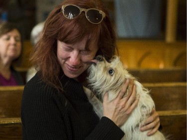 Brandy O'Beirne laughs as she is assaulted with kisses from Rylee, a rescue from California, during The Blessing of the Animals Mass at the Cathedral Church of the Redeemer in Calgary, on October 10, 2015.