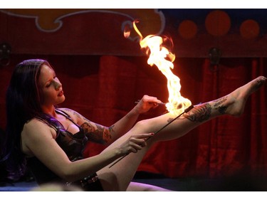 Hellzapoppin performer Tess LaCoil plays with fire during a performance at the Calgary Tattoo & Arts Festival at the BMO Centre on Saturday October 17, 2015.