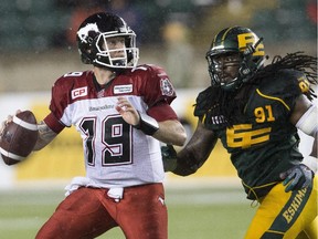 Calgary Stampeders Bo Levi Mitchell (19) is chased down by Edmonton Eskimos Marcus Howard (91) during second half action in Edmonton, Alta., on Saturday September 12, 2015.