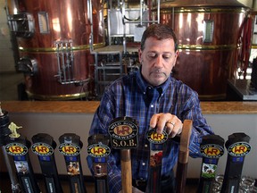 Allan Herman serves up draught at Wild Rose Brewery's Currie Barracks taproom Wednesday, Oct. 28, 2015.