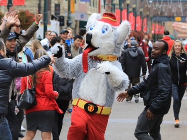 Calgary Flames mascot Harvey the Hound revs up the crowd before Johnny Gaudreau drove a Zamboni down Stephen Avenue Mall in downtown Calgary on Tuesday as part of a promotion with Sport Chek to kick off the start of regular season hockey.