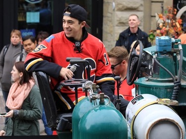 Calgary Flames forward Johnny Gaudreau asks the crowd Flames trivia questions after driving a Zamboni down Stephen Avenue Mall in downtown Calgary on Tuesday as part of a promotion with Sport Chek to kick off the start of regular season hockey.
