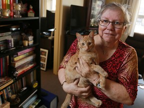 Louise Slade holds her kitten Samantha in her new apartment on Thursday, Oct. 8, 2015. Slade found a pet-friendly apartment with Trinity Place Foundation after being evicted from her old home.