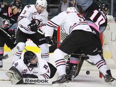 Red Deer Rebels goaltender Rylan Toth finds himself in the middle of a mad scramble as the Calgary Hitmen try to score during third period WHL action at the Scotiabank Saddledome on Friday Oct. 9, 2015. The Hitmen won the game 4-1.