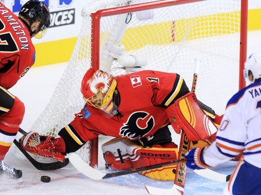 Calgary Flames goaltender Jonas Hiller stops this Edmonton Oilers scoring chance during the first period of NHL action at the Scotiabank Saddledome Saturday October 17, 2015.