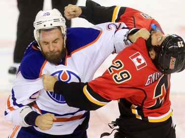 The Edmonton Oilers' Luke Gazdic and Calgary Flames defenceman Deryk Engelland fight during the first period of NHL action at the Scotiabank Saddledome Saturday October 17, 2015.