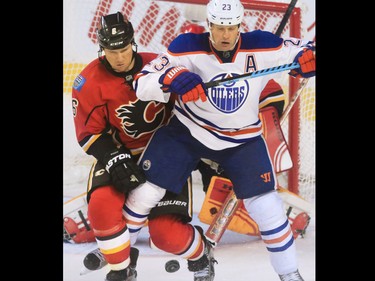 The Edmonton Oilers' Conner McDavid, left celebrates scoring with Nail Yakupov and Benoit Pouliot during the second period of NHL action at the Scotiabank Saddledome Saturday October 17, 2015.